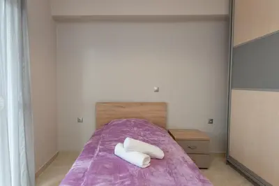 a bedroom with a bed with two towels on it at Mary Luxury House in Émbonas