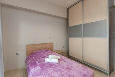 a bedroom with a large bed with purple sheets at Mary Luxury House in Émbonas