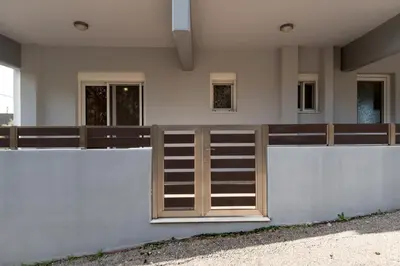 a wooden door on the side of a building at Mary Luxury House in Émbonas