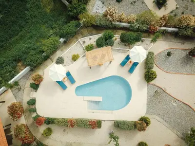 an overhead view of a pool with umbrellas and chairs at Holiday Home Gennadi Dreams Ferienvilla by Interhome in Gennadi