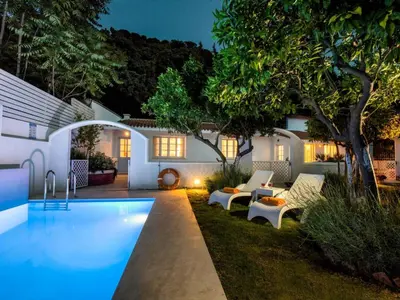a backyard with a swimming pool and a house at Holiday Home Amelie by Interhome in Triánta