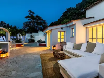 a patio with a white couch and a fireplace at Holiday Home Amelie by Interhome in Triánta