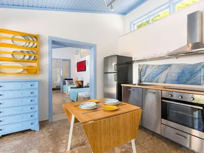 a kitchen with a wooden table in a room at Holiday Home Amelie by Interhome in Triánta