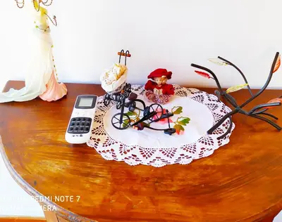 a table topped with a cake with a cell phone at Villa Chrysodimi in Halki
