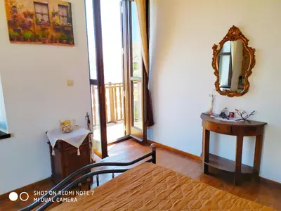 a bedroom with a mirror and a table and a bed at Villa Chrysodimi in Halki