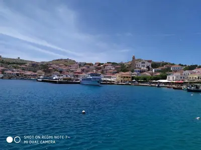 a large body of water with boats in a town at Villa Chrysodimi in Halki