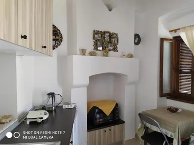 a kitchen with a table and a stove in a room at Villa Chrysodimi in Halki