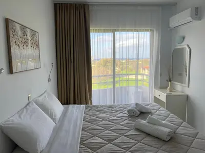 a bedroom with a large bed with towels on it at Ivory Serenity in Theologos