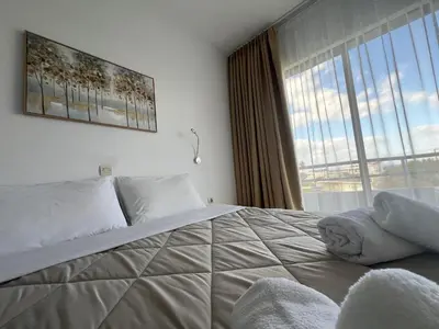 a bedroom with a large bed with a large window at Ivory Serenity in Theologos