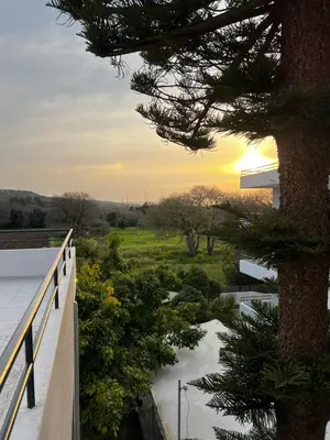 a view of the sunset from the balcony of a house at Ivory Serenity in Theologos