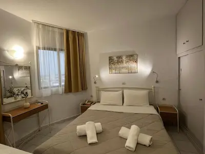 a bedroom with a bed with two towels on it at Ivory Serenity in Theologos