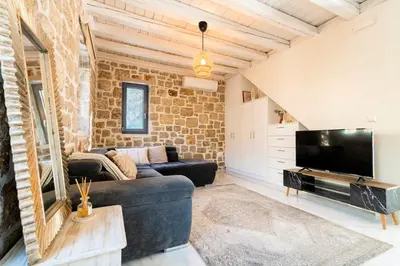 a living room with a couch and a tv at Kastro - Country Villa in Rhodes Town