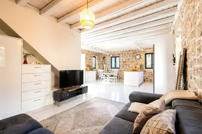 a living room with a couch and a tv at Kastro - Country Villa in Rhodes Town