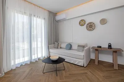 a living room with a couch and a table at Avaton Boutique Suites in Vrachonisída touArchangélou