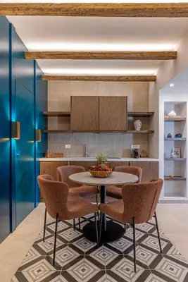 a dining room with a table and chairs at Avaton Boutique Suites in Vrachonisída touArchangélou
