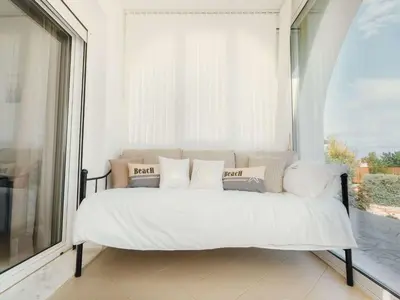 a bed in a room with a large window at Holiday Home Gennadi Dreams Ferienvilla by Interhome in Gennadi