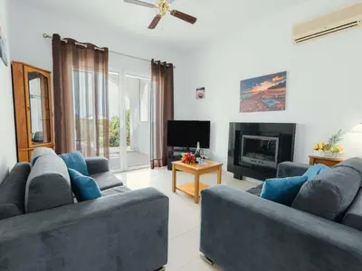 a living room with two blue couches and a fireplace at Holiday Home Gennadi Dreams Ferienvilla by Interhome in Gennadi