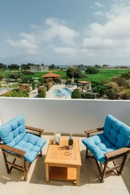 two chairs and a table on a balcony with a pool at Holiday Home Gennadi Dreams Ferienvilla by Interhome in Gennadi