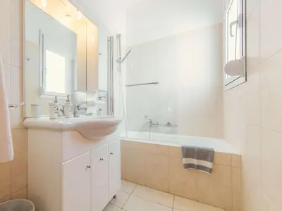 a bathroom with a sink and a tub and a mirror at Holiday Home Gennadi Dreams Ferienvilla by Interhome in Gennadi