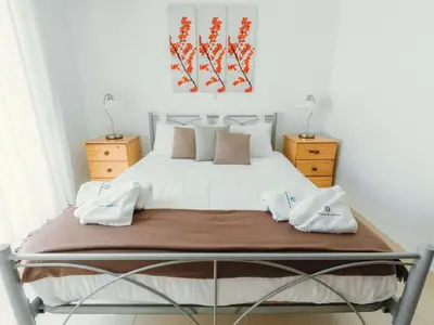 a bed with two towels on it in a bedroom at Holiday Home Gennadi Dreams Ferienvilla by Interhome in Gennadi
