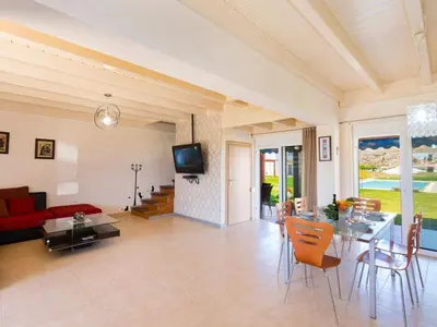 a living room with a red couch and a table at Holiday Home Haus in Kolympia mit Garten und Bergblick by Interhome in Kolimbia