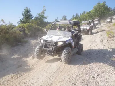 a four wheeler driving on a dirt road at Holiday Home Haus in Kolympia mit Garten und Bergblick by Interhome in Kolimbia
