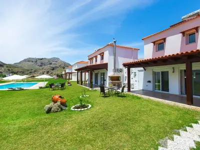 a backyard of a house with a pool at Holiday Home Haus in Kolympia mit Parkplatz und Bergblick by Interhome in Kolimbia