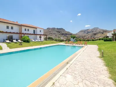 a swimming pool in a villa with mountains in the background at Holiday Home Haus in Kolympia mit Parkplatz und Bergblick by Interhome in Kolimbia