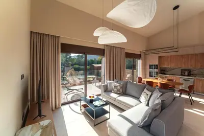 a living room with a couch and a table at Estate Irianna 4 Bedroom Private Pool Villa & 2 Bedroom Guesthouse Rhodes in Ialyssos