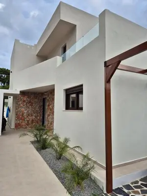 a modern house with white walls at Luxe nieuwe villa met zwembad in Kalithies