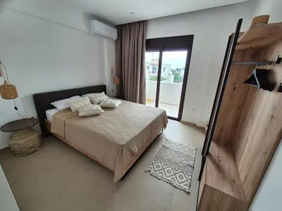 a bedroom with a bed and a sliding glass door at Luxe nieuwe villa met zwembad in Kalithies