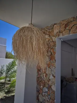 a hanging light hanging from a stone wall at Luxe nieuwe villa met zwembad in Kalithies