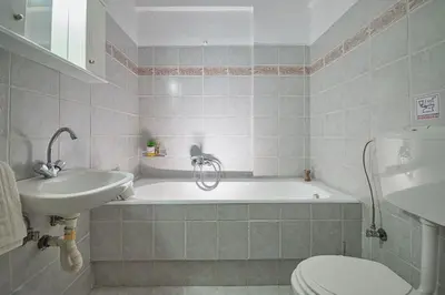 a bathroom with a tub and a sink and a toilet at Anna's view Stegna in Vrachonisída touArchangélou