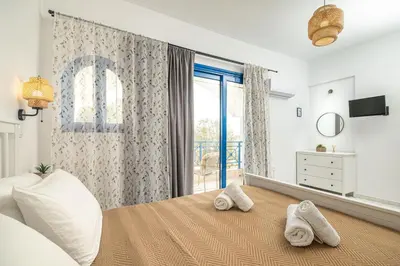 a bedroom with a bed with towels on it at Anna's view Stegna in Vrachonisída touArchangélou