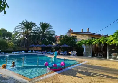 a swimming pool with a mermaid infront of a resort at Paras Sun Hotel & Apartments in Ialyssos