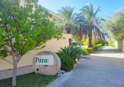 a sign that says pares sitting next to a building at Paras Sun Hotel & Apartments in Ialyssos