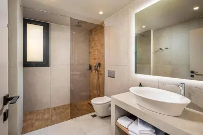 a bathroom with a sink and a toilet and a shower at Villa Terra Magna Alba by Villa Plus in Gennadi