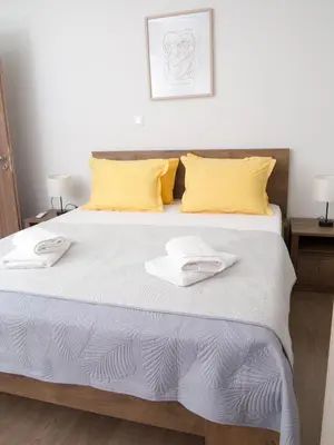 a bedroom with a bed with two towels on it at My Home in Ialyssos in Ialyssos