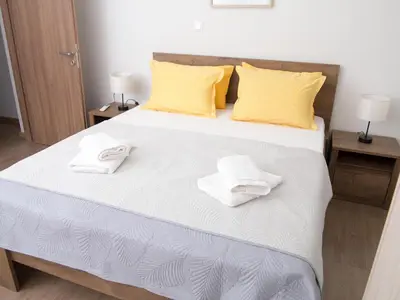 a bedroom with a bed with two towels on it at My Home in Ialyssos in Ialyssos