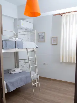 a bunk bed in a room with a ladder at My Home in Ialyssos in Ialyssos