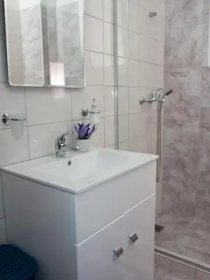 a bathroom with a white sink and a shower at My Home in Ialyssos in Ialyssos