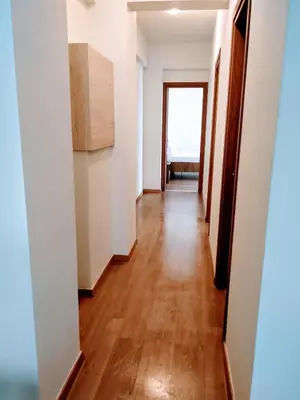 a hallway of an apartment with white walls and wooden floors at My Home in Ialyssos in Ialyssos