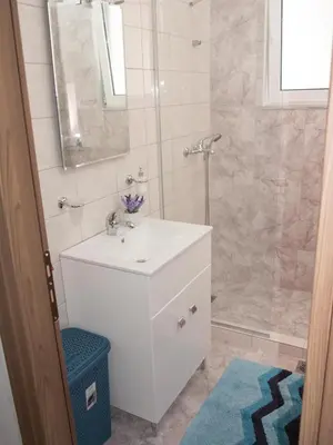 a bathroom with a white sink and a shower at My Home in Ialyssos in Ialyssos
