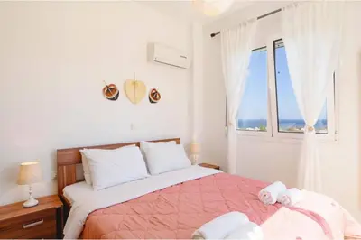 a bedroom with a bed with a view of the ocean at Villa Nicole Gennadi in Gennadi