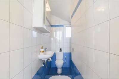 a white bathroom with a toilet and a sink at Villa Nicole Gennadi in Gennadi