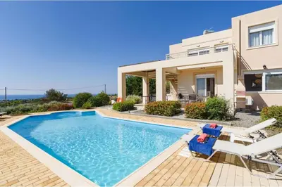a villa with a swimming pool and a house at Villa Phoebe Gennadi in Gennadi
