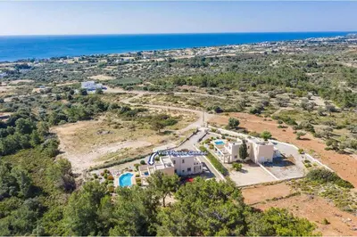 an aerial view of a house on a hill next to the ocean at Villa Phoebe Gennadi in Gennadi