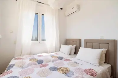 a bedroom with a bed and a window at Villa Phoebe Gennadi in Gennadi