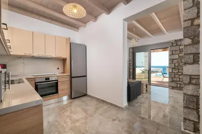 an open kitchen with a view of the ocean at Pefkos Sea Serenity Villas in Líndos