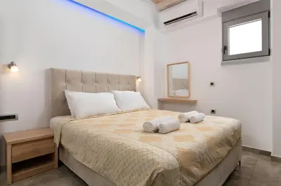 a bedroom with a large bed with towels on it at Pefkos Sea Serenity Villas in Líndos